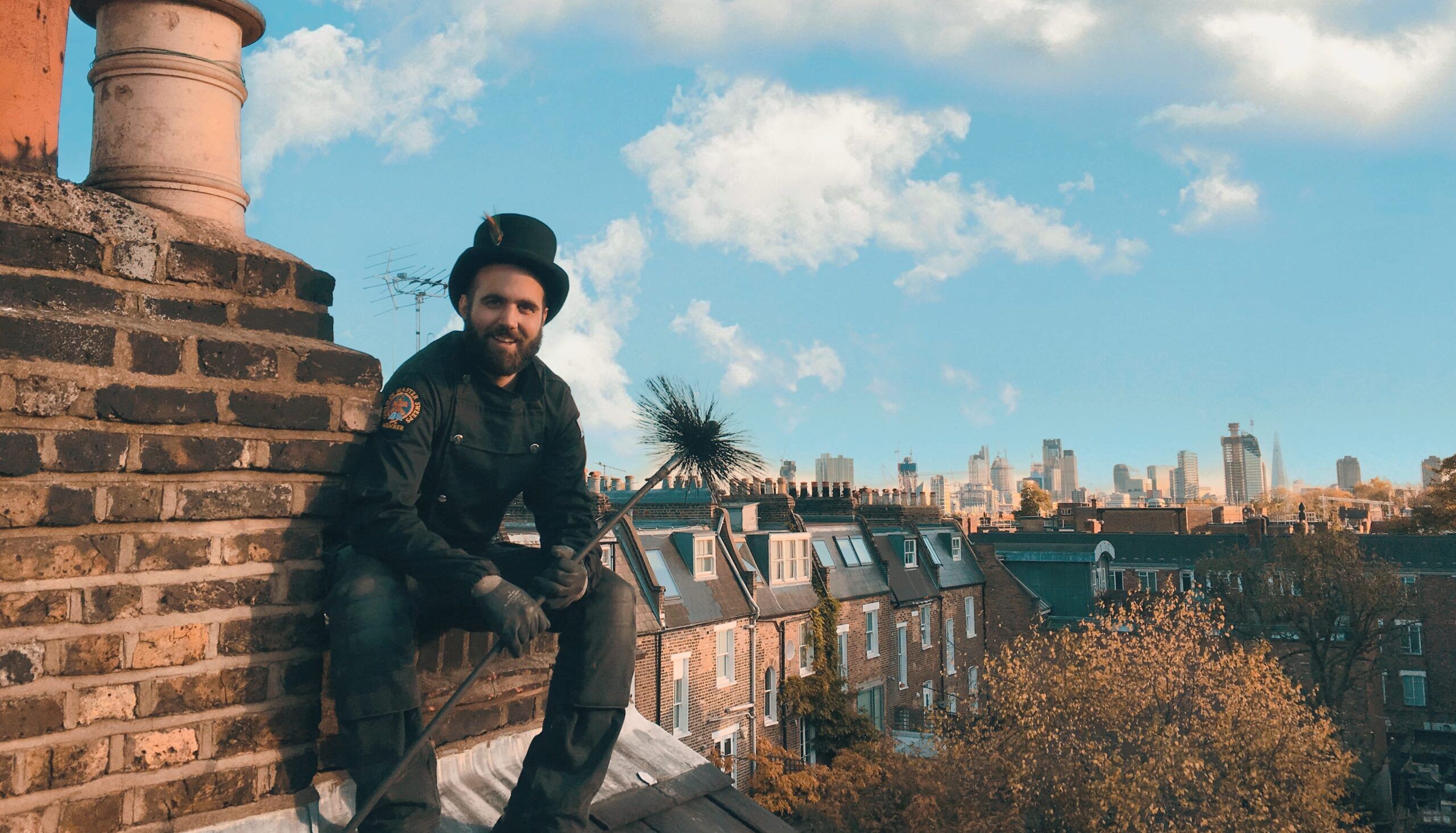 Chimney sweep on rooftop Chimney sweep on rooftop